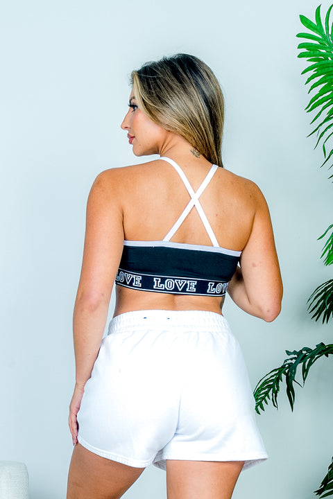 'LOVE' V Neck Sports Bra with Sporty White Contrast Piping and Criss Cross Strappy Detail in Black (AT52306) - Wholesale Fashion Couture 